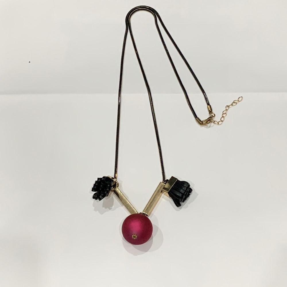 Black necklace with red dangling ball